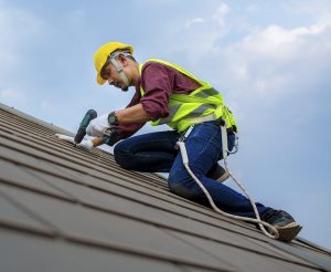 A roofing professional performing a roof repair