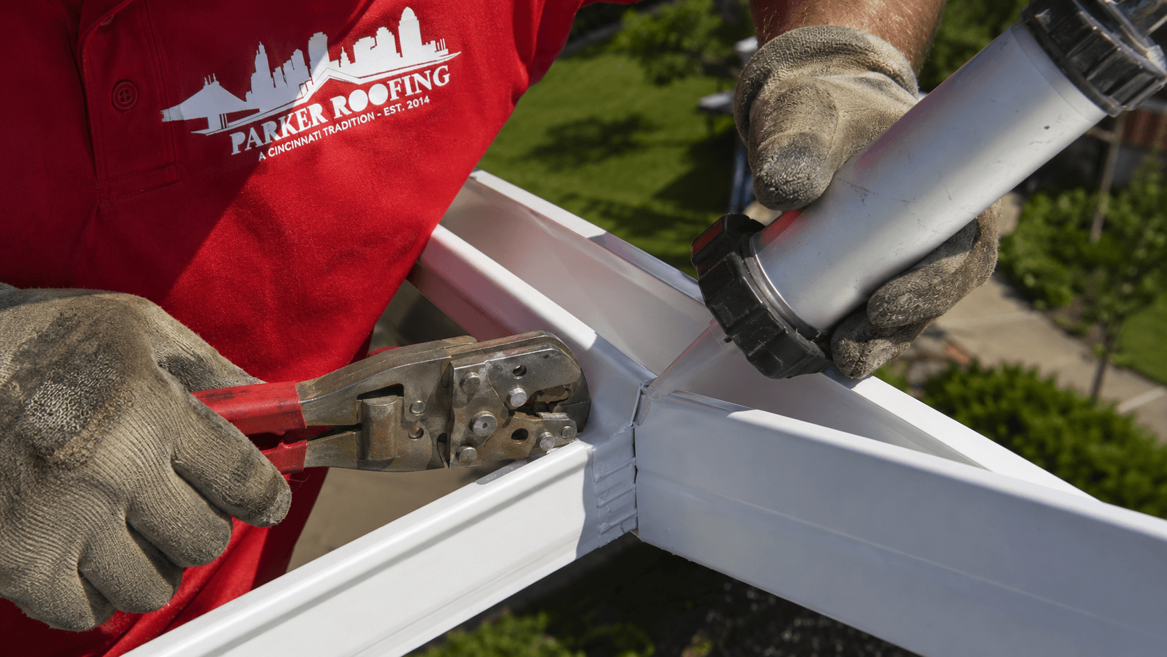 Parker Roofing crew installing seamless gutters on a Cincinnati home